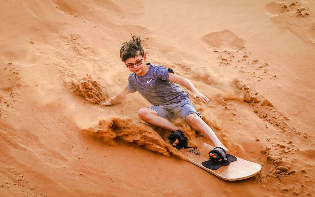 Abu Dhabi Premium Desert Safari with BBQ Dinner, Camel Ride and Sandboarding Image 3
