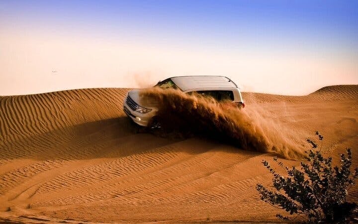 Dubai Evening Desert Safari with Dune Bashing, Camel Ride, Sandboarding, Live Shows & BBQ Dinner Image 4