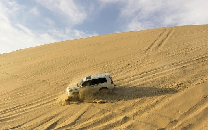Dubai Evening Desert Safari with Dune Bashing, Camel Ride, Sandboarding, Live Shows & BBQ Dinner Image 9