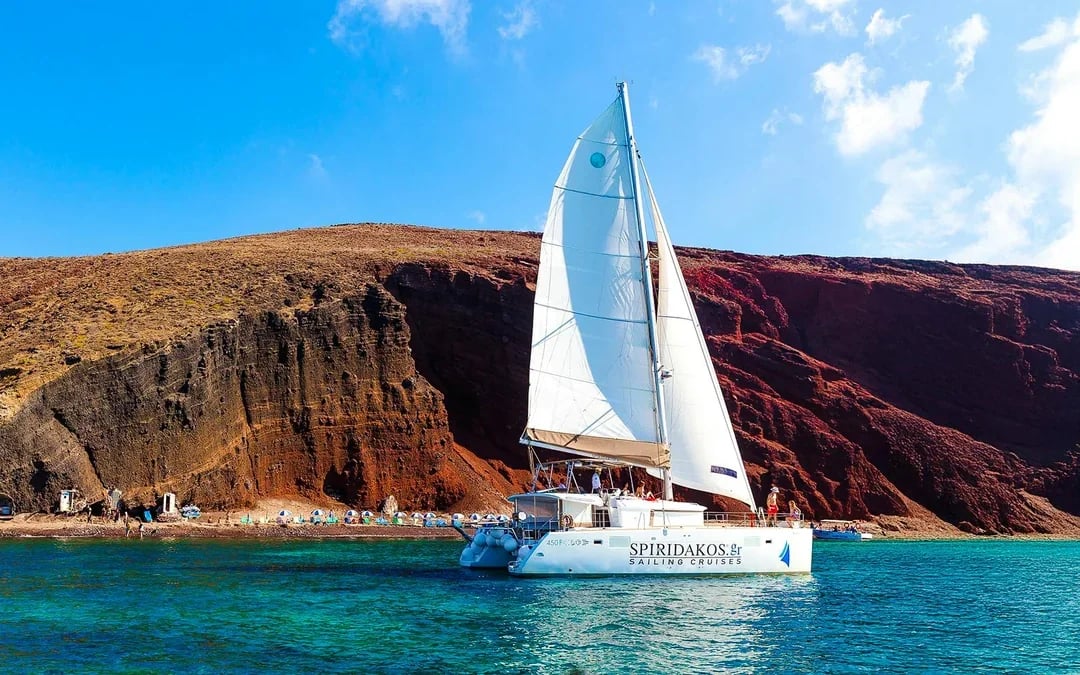 From Santorini: Premium Catamaran Cruise with Meal, Drinks & Transfers Image 1