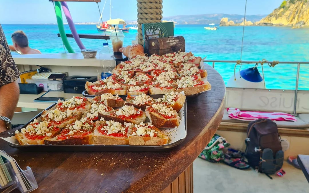 Kefalonia Day Cruise to White Rocks Beach and Vardiani Island with Homemade Greek Cuisine Image 5