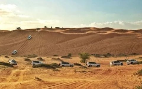 Ras Al Khaimah Desert Safari with Dune Bashing, Camel Ride, Sand Boarding, BBQ Dinner, and Transfers Image 1